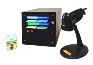 The Scribe Mini comes with a scanner, shown here with a stand and stack of cartridges. The Mini is currently duplicating two cartridges, one peach and one green, which are plugged into the lower two cartridge slots.